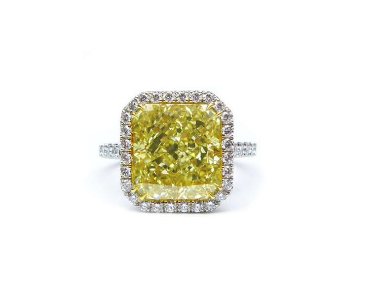 This fabulous GIA certified 5.38 carat fancy light yellow radiant diamond is set in platinum with a 0.88ctw diamond frame. This ring is perfect for the woman who loves to sparkle and make a statement!