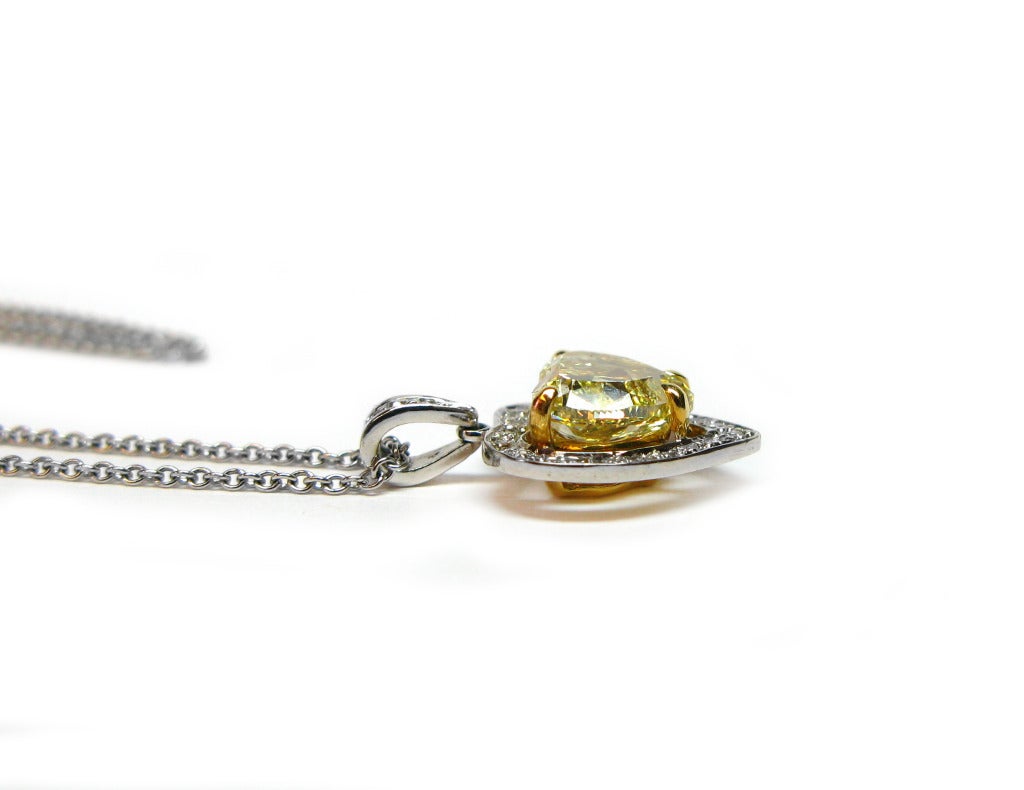 This gorgeous 18kt two-tone gold pendant features a GIA certified, 1.74ct Fancy Brownish Yellow color, VS2 clarity, heart elegantly framed with 0.19ctw of round brilliant diamond pave. This pendant is sure to bring sparkle and color to any outfit!