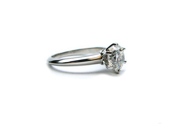 This 1.31 carat GIA certified I color VS1 clarity round brilliant cut diamond is set with 6 prongs in a stunning platinum Tiffany & Co. signed ring. This ring brings classic beauty to the modern day bride.