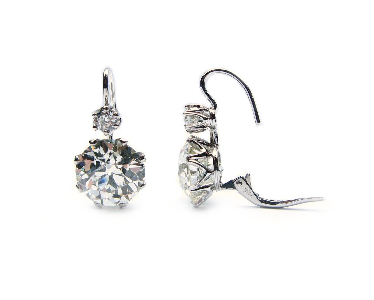 This stunning pair of platinum leverback earrings features a GIA certified 6.45ct, K color, VS1 clarity Old Euro diamond and a GIA certified 6.64ct, K color, VS2 clarity Old Euro diamond drop each with a 0.25ct Old Euro diamond top. These