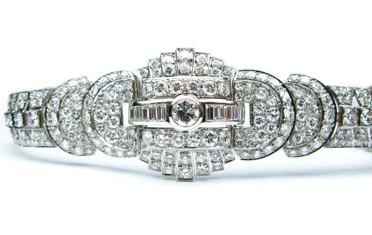 This French signed, platinum diamond bracelet, features an approximate 1.35 carat F/G VS bezel set round brilliant diamond, surrounded by 269 round and baguette diamonds to create a 25ctw knock-out statement piece. The perfect addition to your