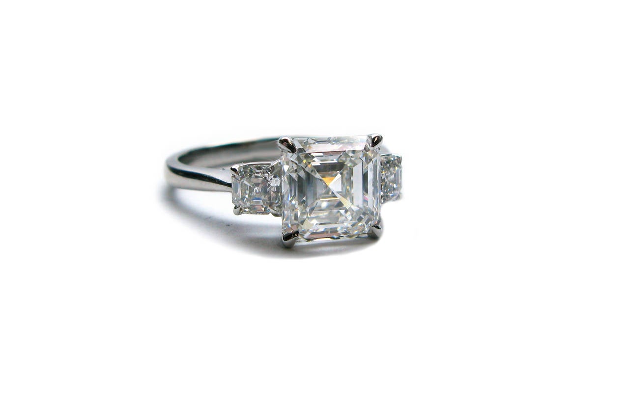 This beautiful handmade platinum ring features a GIA certified 2.50ct, F color, VS1 clarity, Asscher cut diamond center with 0.48ctw Asscher cut diamond sidestones. A true classic!
