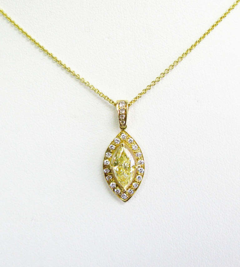 This piece comes from J.Birnbach's highly-curated Fancy Yellow Diamond collection. The 18-karat yellow gold pendant features a gorgeous 0.82 carat fancy light yellow marquise-shaped diamond, with VS2 clarity, and is surrounded by 0.14 carats of