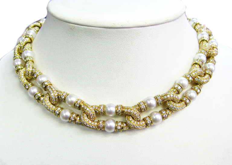 This yellow gold, diamond and pearl double strand necklace is guaranteed to make a statement at your next cocktail party! This piece features round brilliant diamonds and lovely cultured pearls in an intertwining setting that rests beautifully on