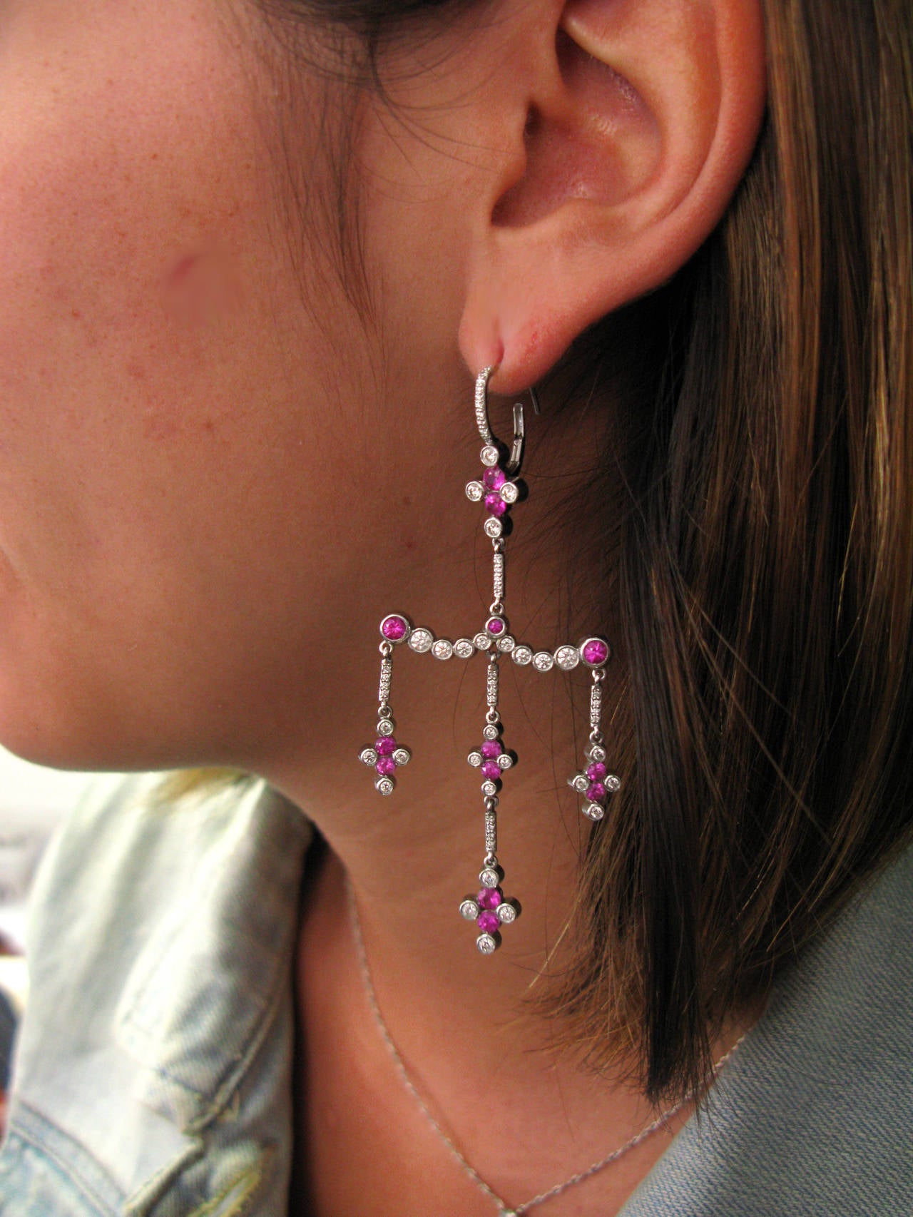 These one-of-a-kind spectacular platinum leverback chandelier earrings contain 2.60ctw of round rubies and 1.48ctw of bezel set round brilliant diamonds. Truly as unique as the lucky woman who gets to wear them!