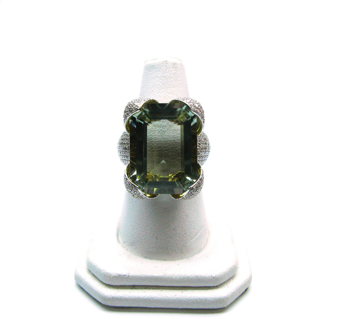 This stunning one-of-a-kind 18kt two-tone gold ring features a 20mm x 14.91mm step cut prasiolite (green quartz) gemstone held in place with pave diamond accented petal-like prongs. This whimsical piece is for the creative woman who dares to be