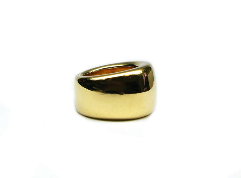 This chunky, 18 karat yellow gold ring is signed Christian Dior. It features a 13.8 mm tapered design, and weighs 17.11 grams. The simple, yet classic design of this ring is the ultimate way to add just the right amount of gold to any outfit!