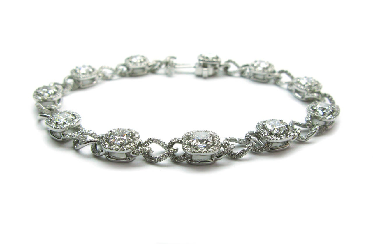 This unique platinum bracelet features 11 pave frame cushion cut diamonds weighing 5.01ctw with round brilliant diamond encrusted pave links weighing 2.68ctw. This one-of-a-kind design cannot be found elsewhere so don't miss out!