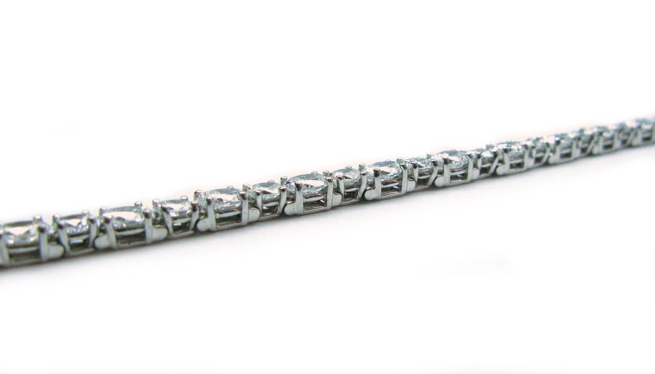 This beautiful platinum bracelet features a twist on the classic tennis by alternating larger and smaller oval cut diamonds. There are 36 horizontally set, E color, VS clarity stones, totaling 11.14cts. Perfect for every day wear or for those extra