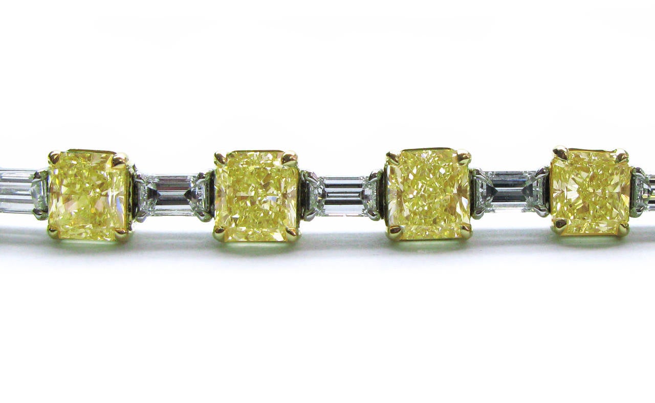 This beautiful platinum and 18kt yellow gold bracelet features 16 natural fancy yellow color square radiant cut diamonds totaling 18.12ctw alternating with 16 white straight baguette diamonds totaling 4.21ctw. This fantastic piece can be worn day or
