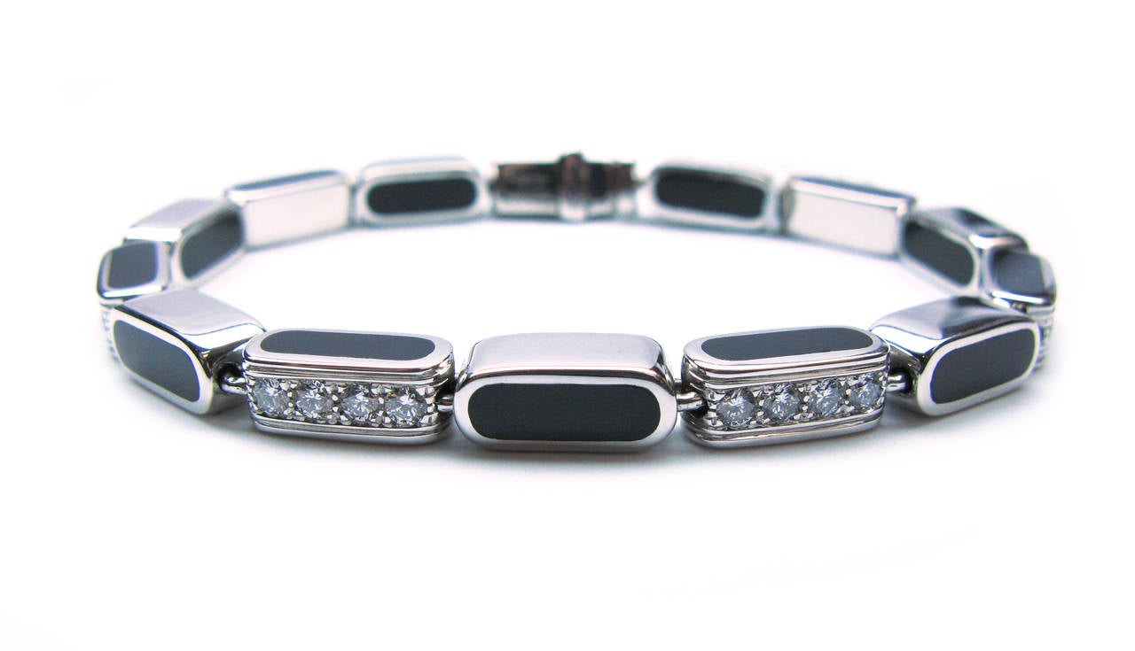 This modern 18kt white gold Asprey signed bracelet features alternating black onyx polished bars with pave set diamonds on every other link. The round brilliant diamonds weigh a total of 0.47cts. Don't forget to check out the matching pendant and