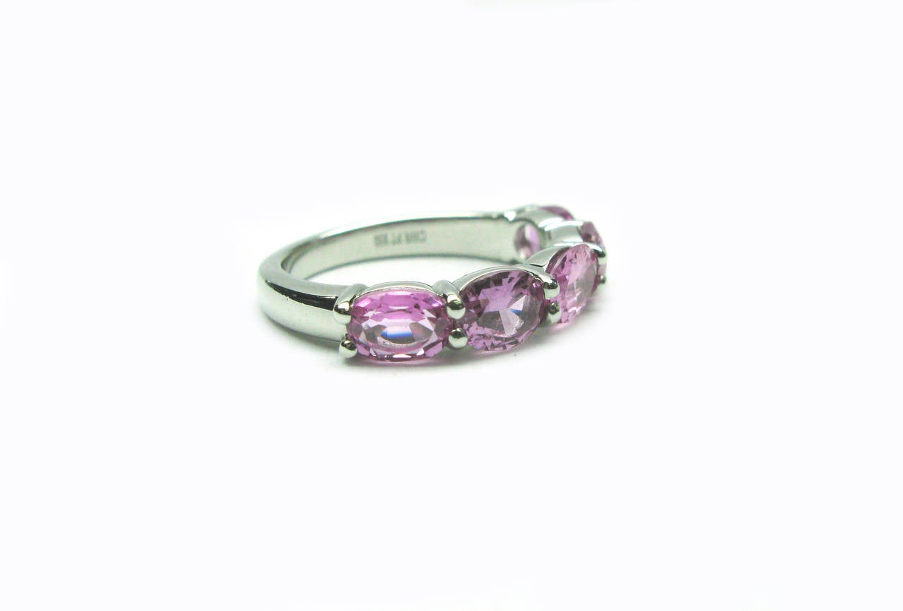 This pretty platinum band features 5 faceted oval cut sapphires set east-west in a lovely shade of deep pink. The gemstone total weight is 4.27cts. This simple, yet stunning band will quickly become a staple in your jewelry box.