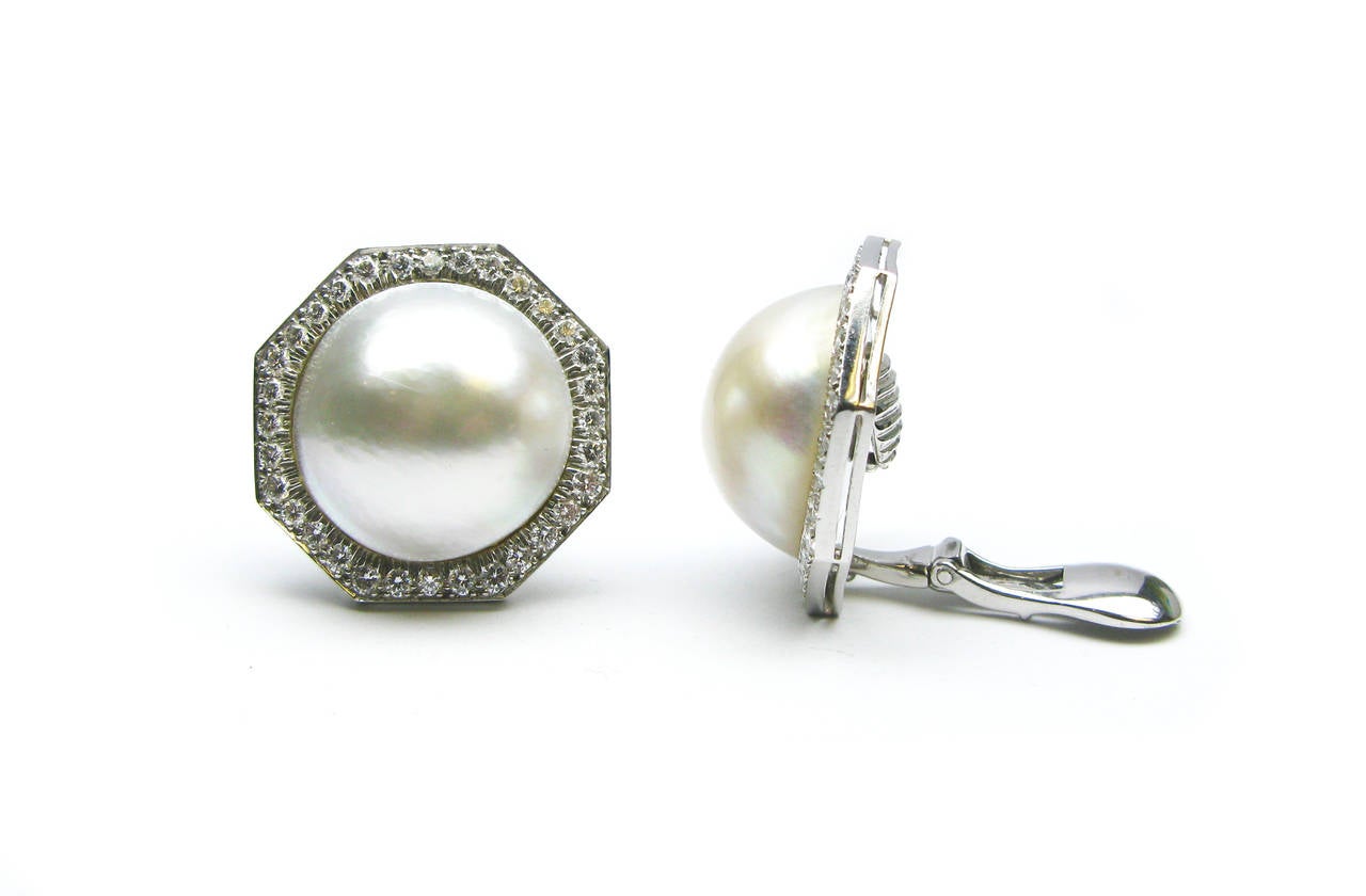 These lovely David Webb signed earrings are set in platinum and 18Kt white gold and feature two gorgeous cultured pearls. They are encompassed by an octagon of diamond pave, creating a delicate statement piece perfect for the classic lady.