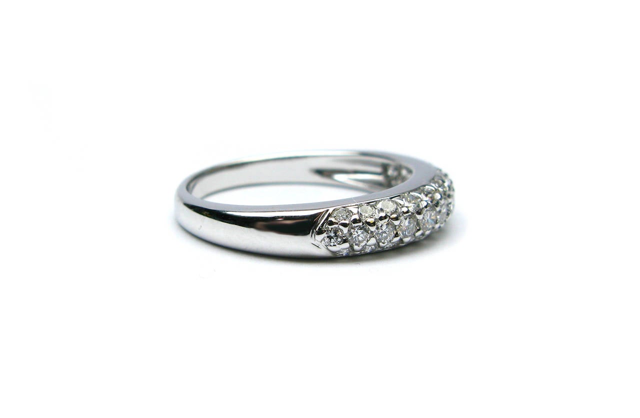 This gorgeous Italian white gold wedding band features three rows of pave diamonds that weigh approximately 1.00 carats. This band is perfect to accompany any style engagement ring to add some major sparkle to your look! Don't let this piece get