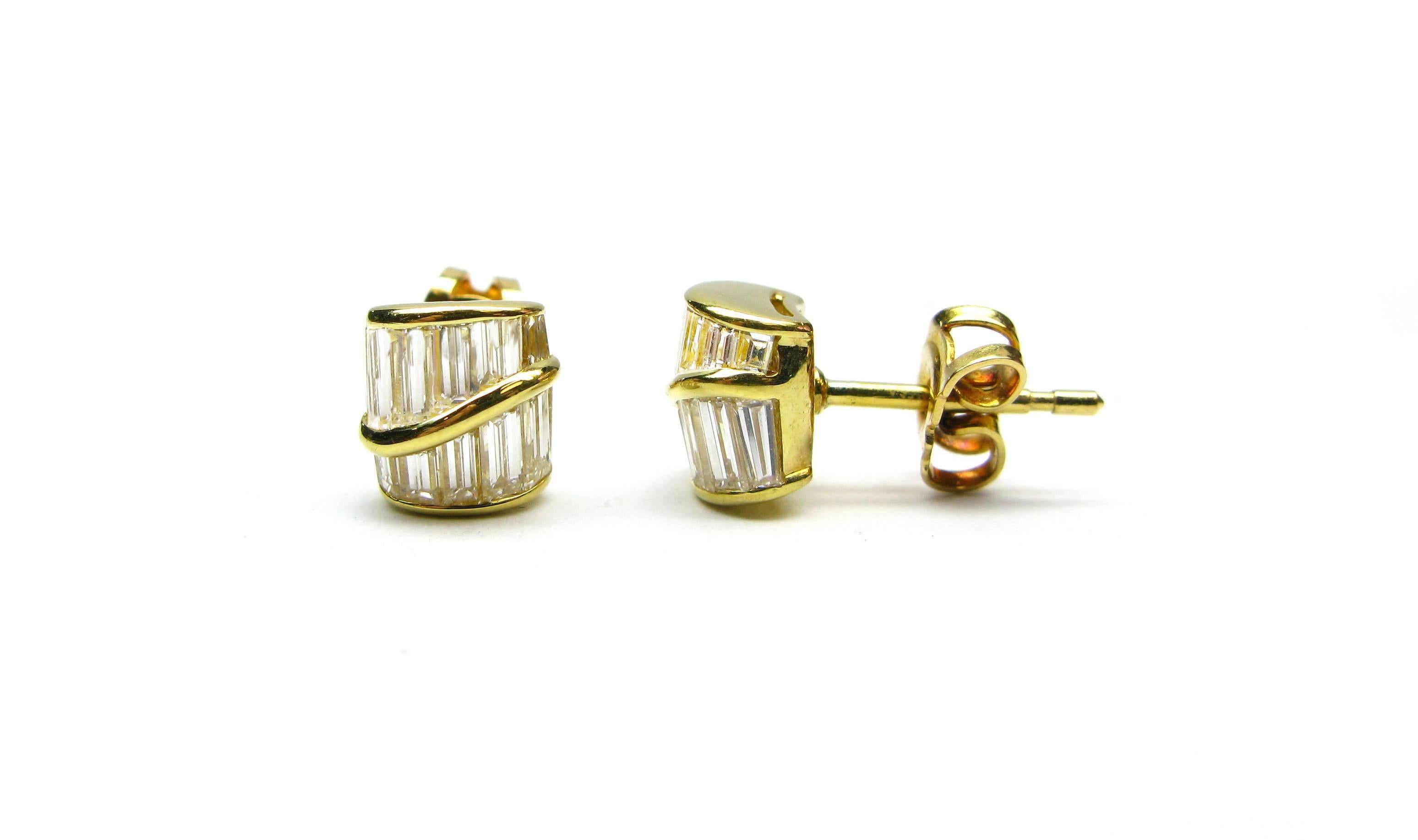These lovely earrings are part of the Kurt Wayne collection. This unique alternative to the basic round brilliant stud features 1.76ctw of straight baguette diamonds bezel set into highly polished 18kt yellow gold. Be the envy of all your friends