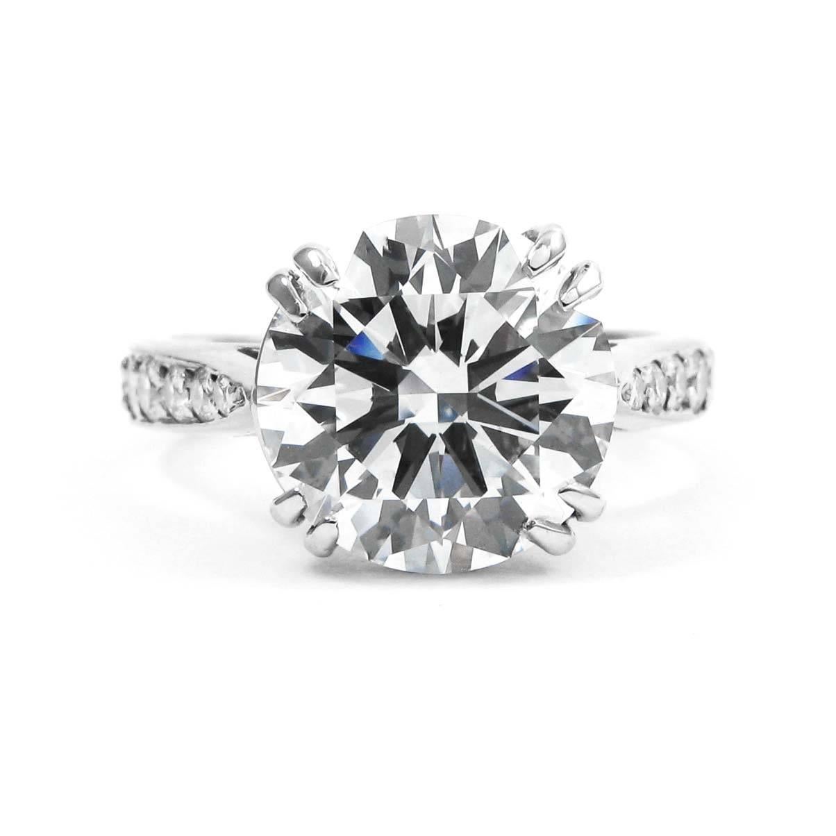 The beautiful handmade platinum engagement ring features a 3.57 carat, F color, VS2 clarity, sparkling Round Brilliant diamond center stone with a graduating pave set round brilliant diamond band. The only response after seeing this ring will be