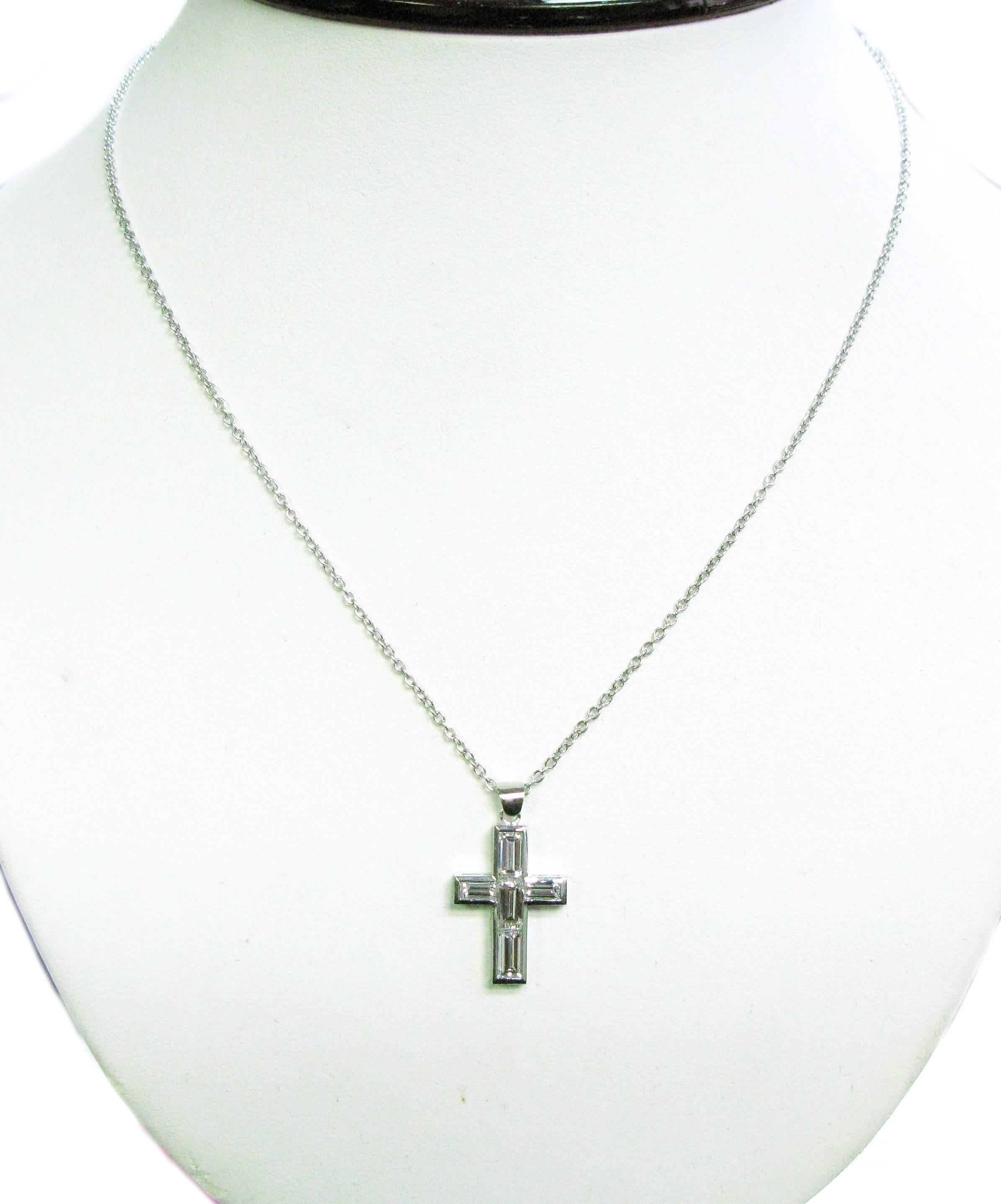 This classic cross pendant features 5 F/G color, VS1 clarity, diamond baguettes totaling 2.06cts. The pendant is set in 18kt white gold and is suspended from an 18