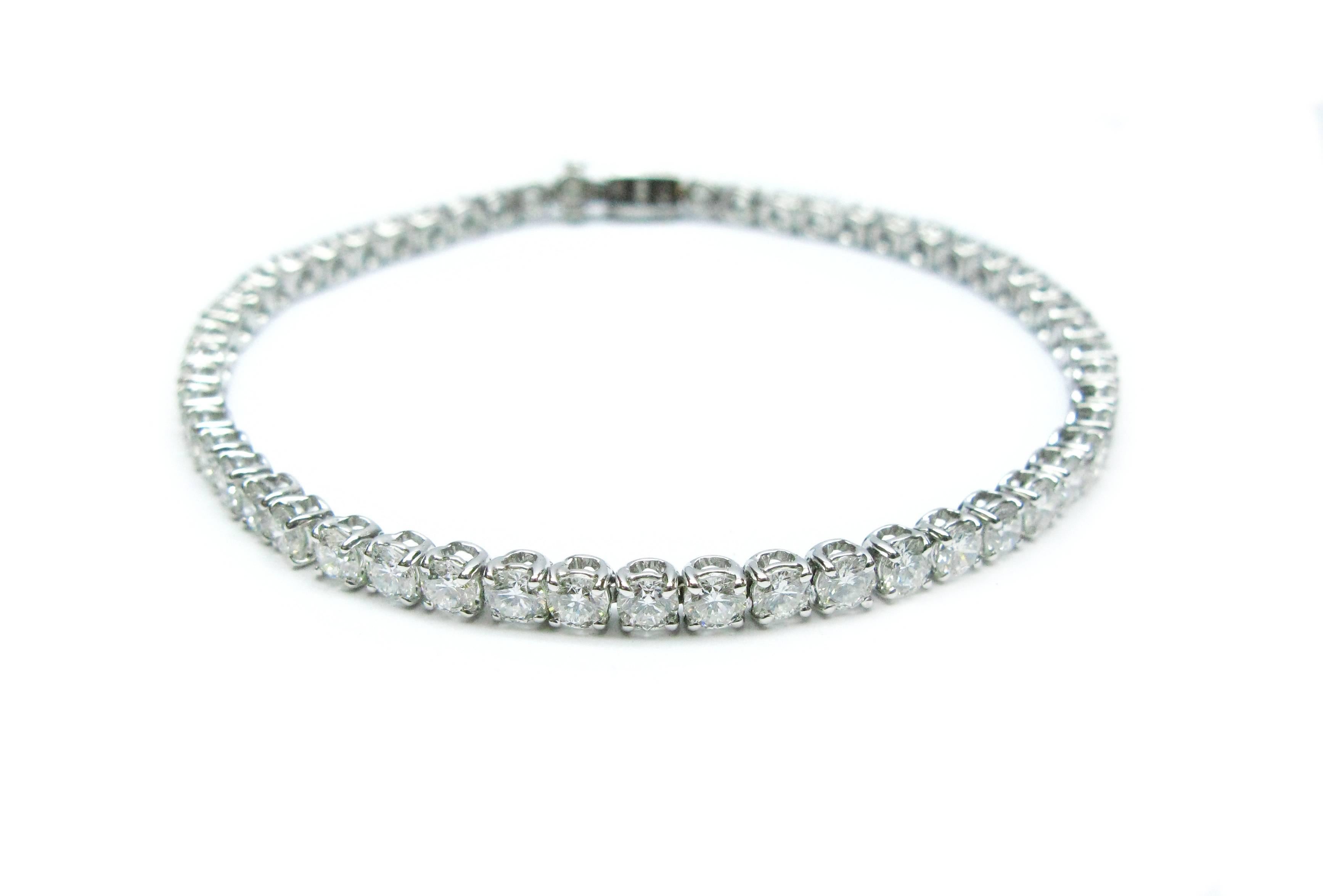 This beautiful Bulgari tennis bracelet is part of the Griffe collection. It features 55 sparkling F/G color, VS clarity, Round Brilliant cut diamonds set into 18kt white gold 4-prong baskets. The combined weight of these gemstones is 6.12cts. This