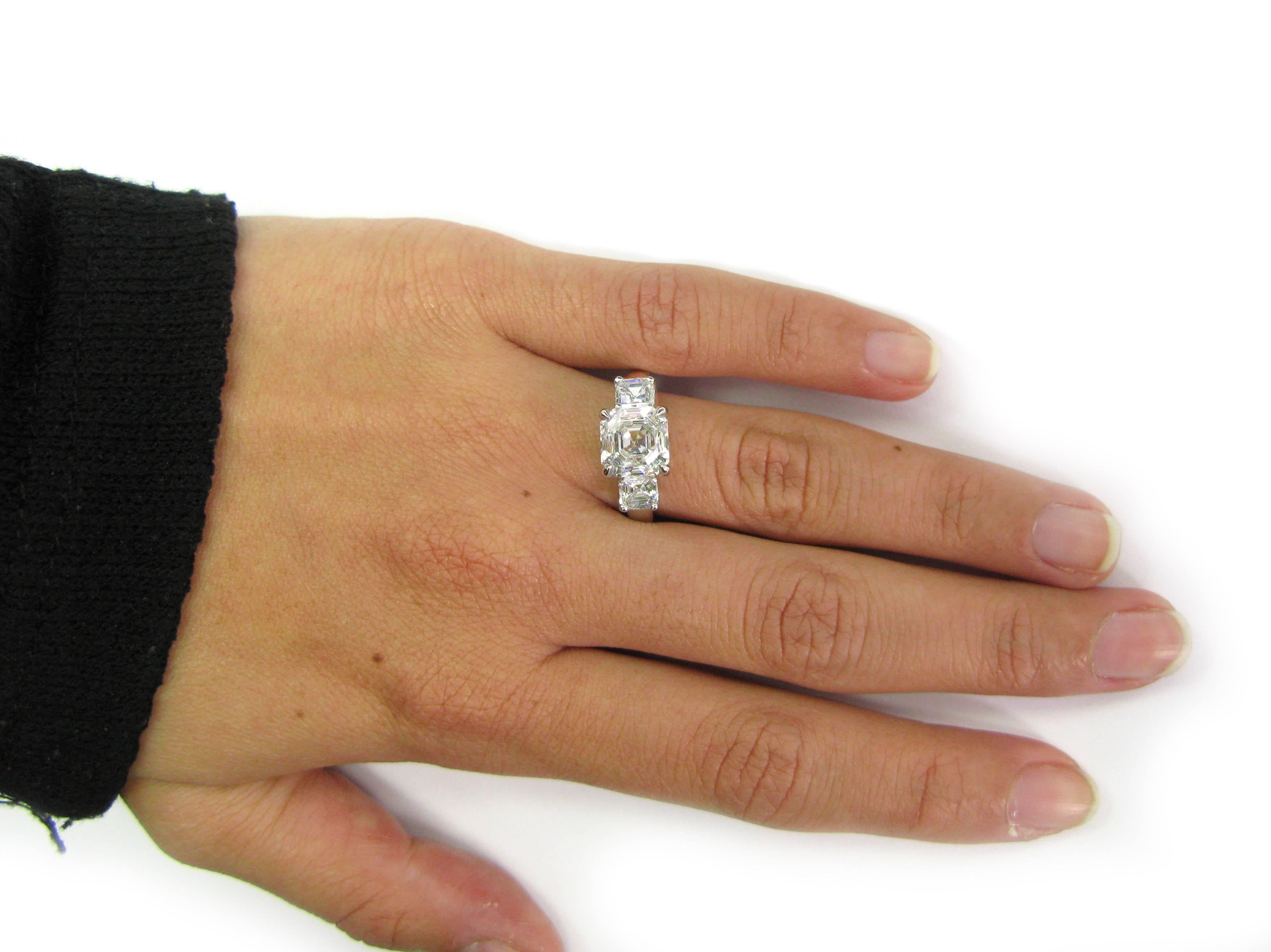 This lovely handmade platinum ring features 3.01 carat, F color, VS1 clarity, Asscher-cut diamond center stone flanked by two smaller Asscher-cut diamonds totaling approx. 0.95 ctw. This stunning piece would make a perfect engagement or anniversary
