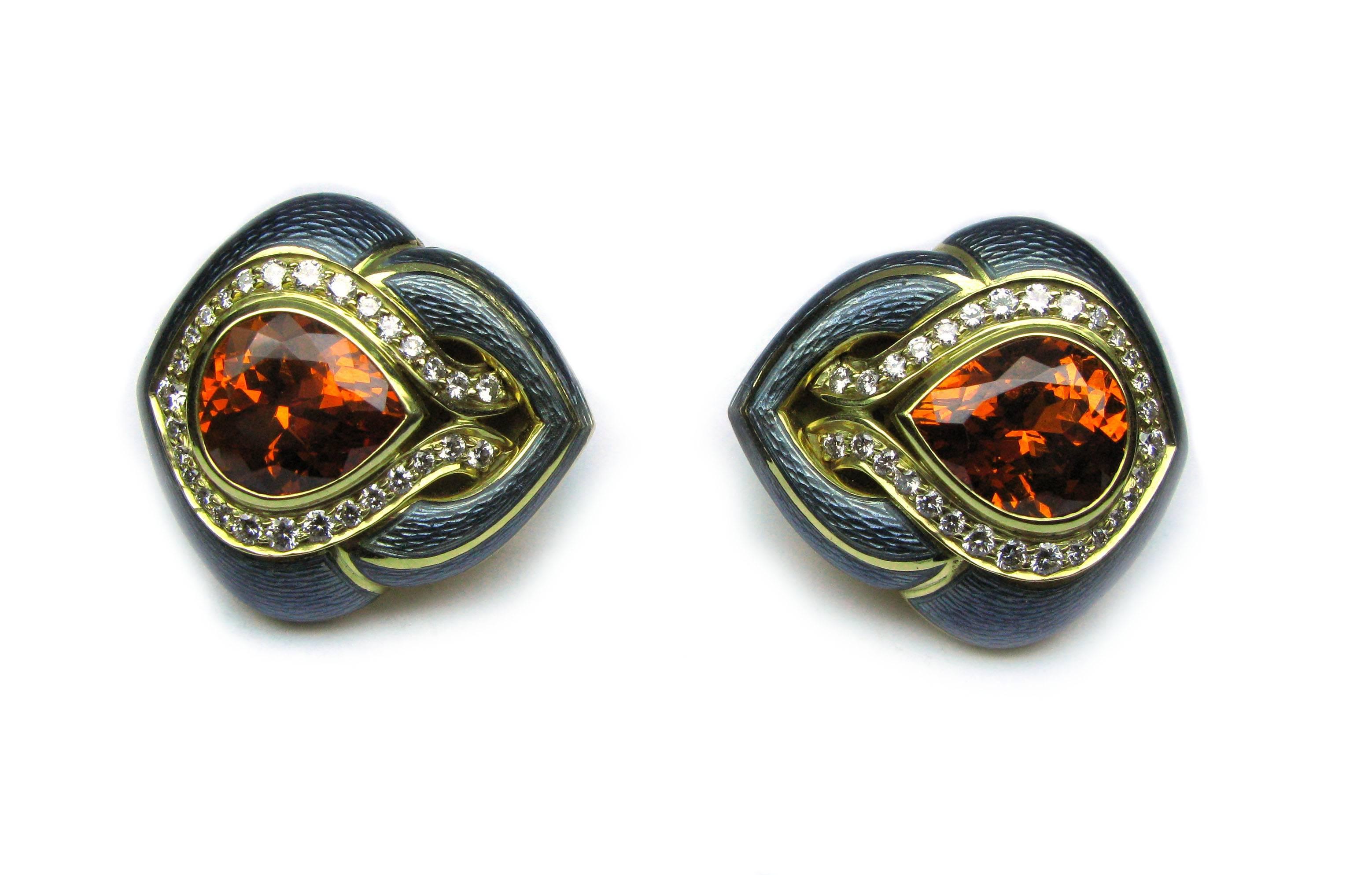 These captivating 18kt yellow gold gray enamel De Vroomen signed ear clips feature 12.67ctw pear shaped mandarin garnet center stones framed with 1.00ctw of round brilliant diamonds. The pop of color and unique style make these earrings an excellent