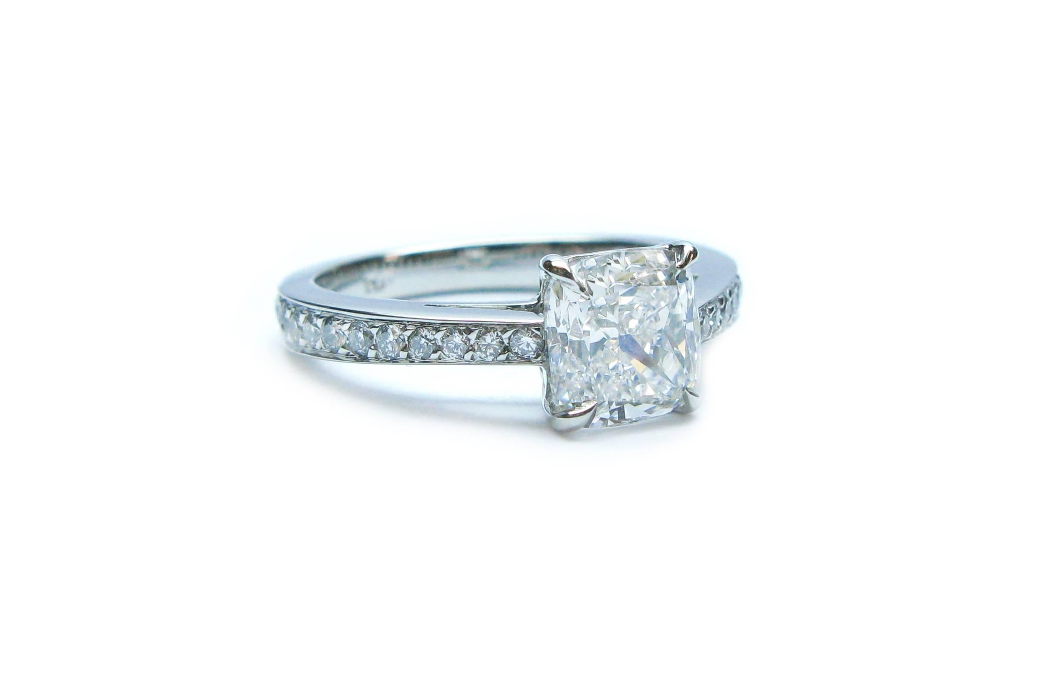 This charming handmade platinum engagement ring features a GIA certified 1.81ct, F color, VS1 clarity, cushion diamond center stone with 0.45ctw of pave set round brilliant diamonds down the band. This lovely engagement ring will be the perfect