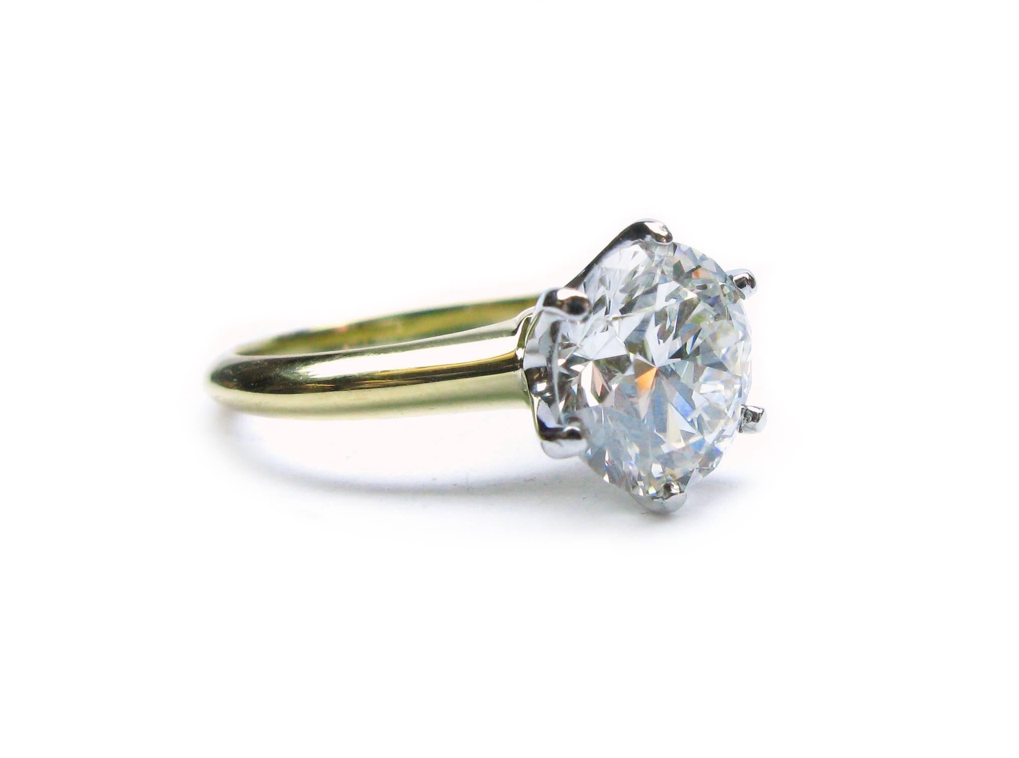 This stunning platinum and 18kt yellow gold Tiffany & Co. signed solitaire ring features a GIA certified 2.25ct, H color, VS1 clarity, Round Brilliant diamond set into a 6-prong head. This classic beauty will be turning heads in every direction!