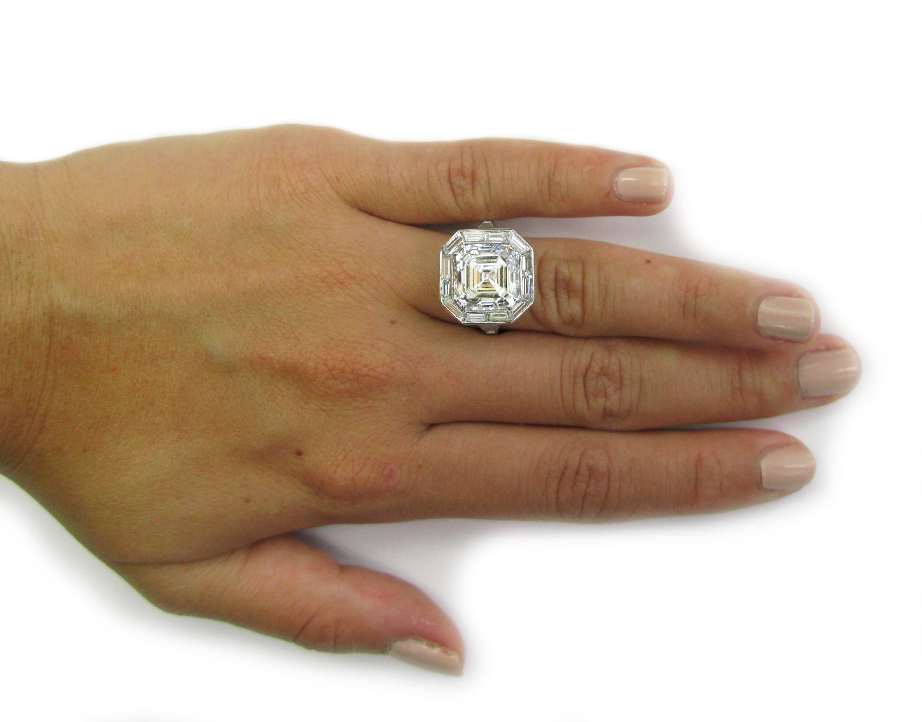 This fantastic handmade platinum ring contains approximately 2.50ctw of straight baguette diamonds forming a frame around a 6.01 carat Asscher-cut diamond with H color and SI1 clarity. This beauty will have all the heads turning in your
