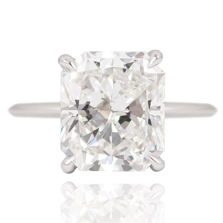 Showcasing a GIA Certified 4.41 ct Radiant cut diamond, words simply do not do this ring justice. The platinum mounting features subtle, charming pave details throughout the under gallery (0.32 ctw) that further add to the sophisticated aesthetic of