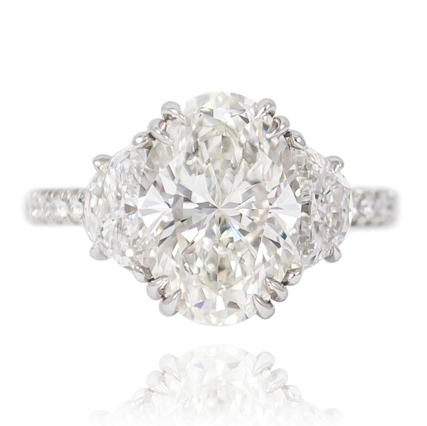 The scintillating sparkle of this diamond ring is mesmerizing! Featuring a 3.07 ct oval cut diamond flanked by a pair of half moons = 0.89 ctw and a diamond pave shank = 0.42 ctw , this ring is a very large look. 

Purchase includes original GIA