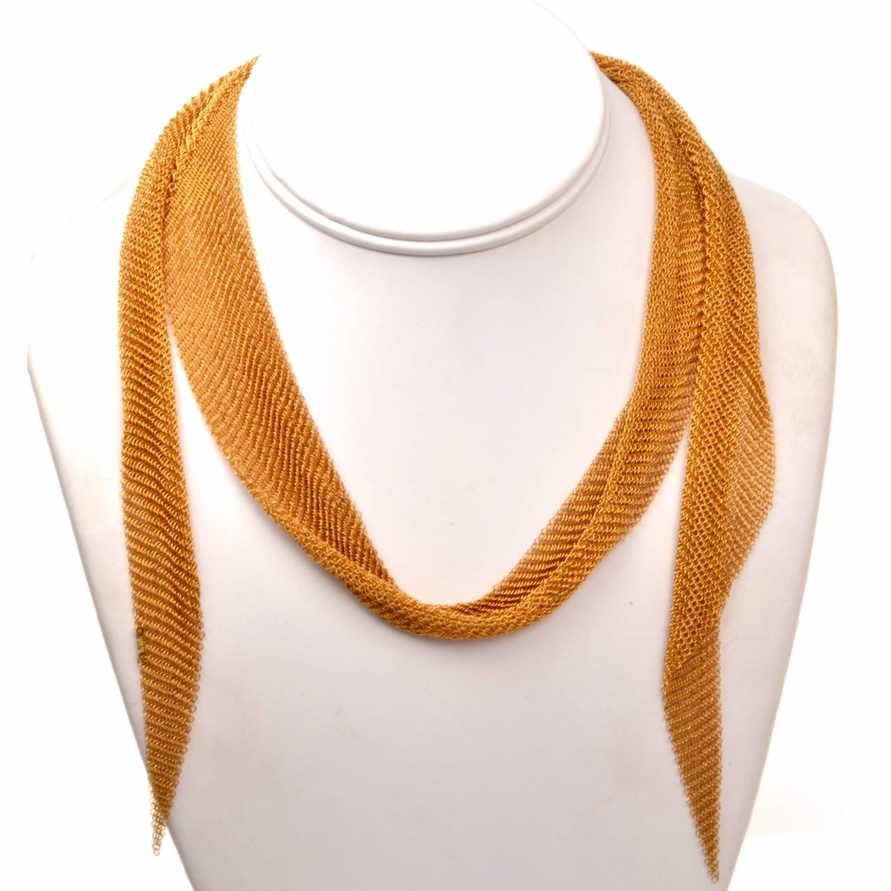This authentic Elsa Peretti scarf necklace designed for and manufactured by Tiffany & Co. is crafted in solid 18K yellow gold. Like most of Peretti's mesh gold collection which was inspired in Jaipur, India, this enchantingly delicate scarf necklace