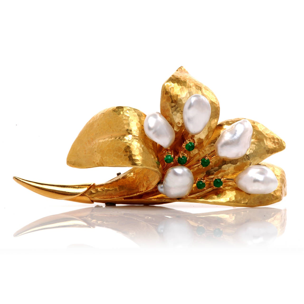 This magnificent floral pin is handcrafted in solid 18K yellow gold hand- hammered finish. This pin exposes a lovely Lily flower with 5 natural lustrous pearls and centered with 6 genuine cabochon emeralds approx 0.75cttw, prong set. This item is in