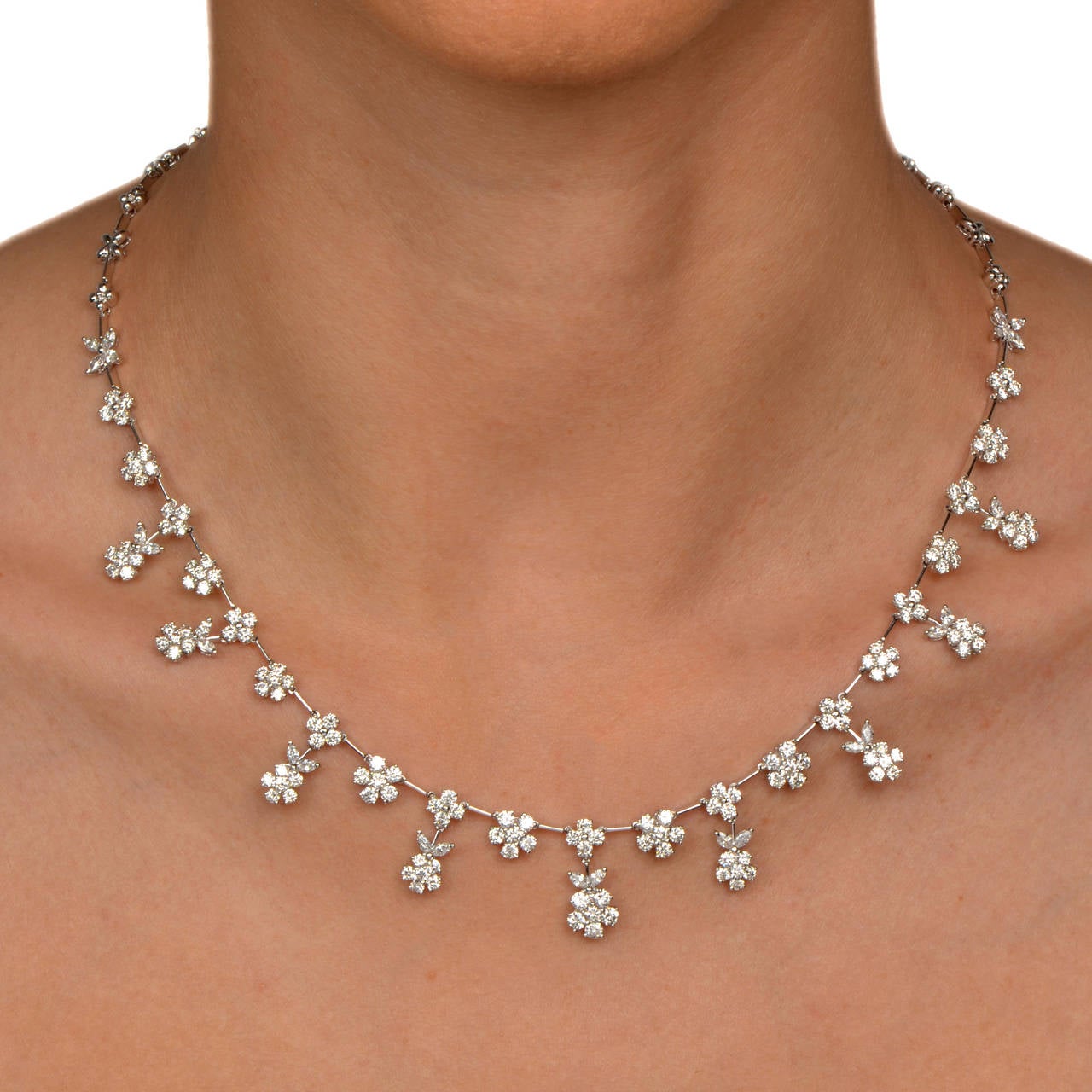 This dazzling and very feminine necklace is crafted in solid 18K solid white gold. This gorgeous diamond piece displays a flower shaped motif throughout and is accented with 158 genuine round cut diamonds and 26 genuine marquise cut diamonds all