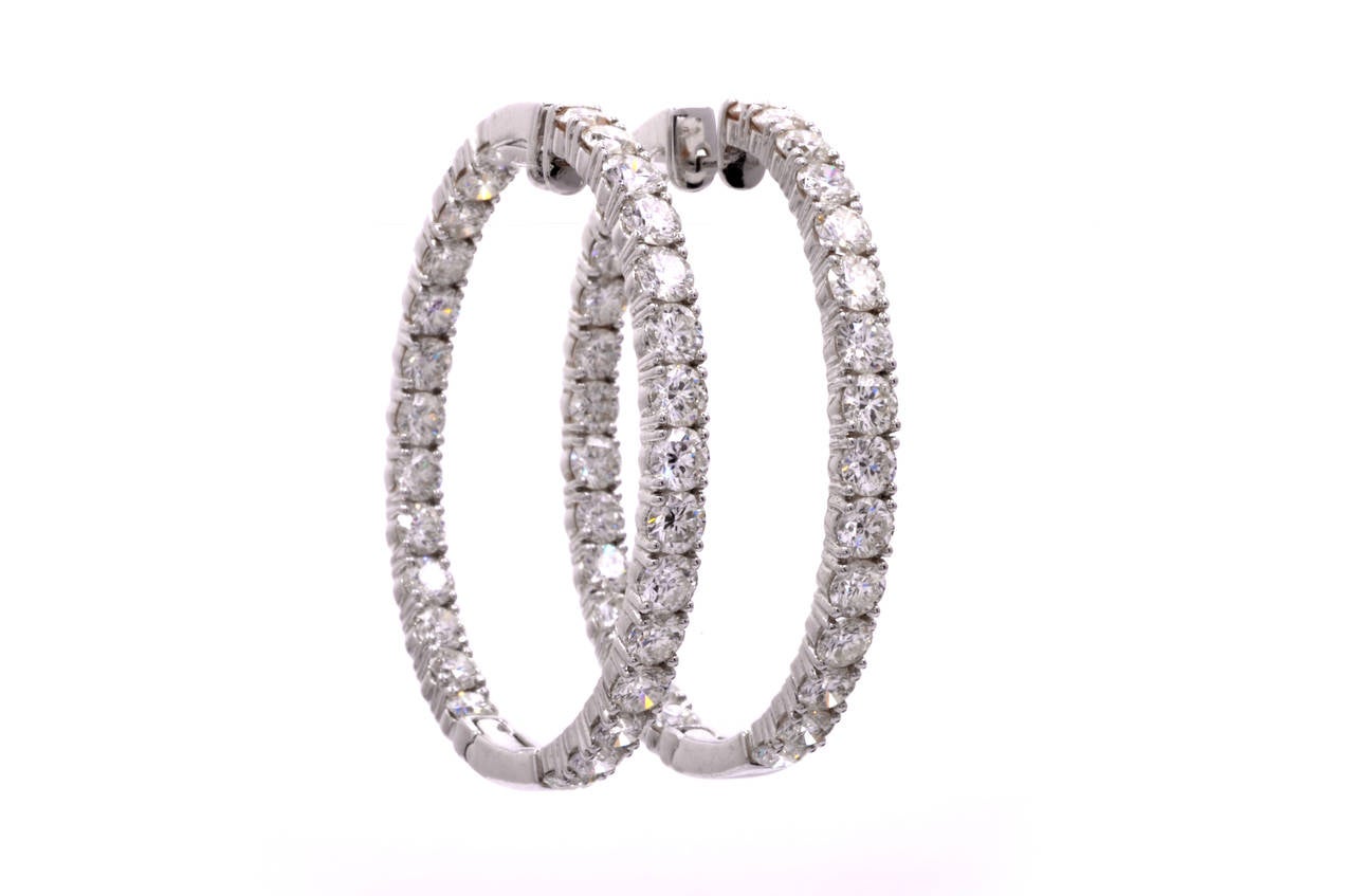 These captivating  diamond hoop earrings reminiscent of the popular 19th century Iberian creole earrings are crafted in solid 18K white gold, weighing 21.2 grams. These eye-catching earrings are resplendent in 56 genuine round-faceted diamonds