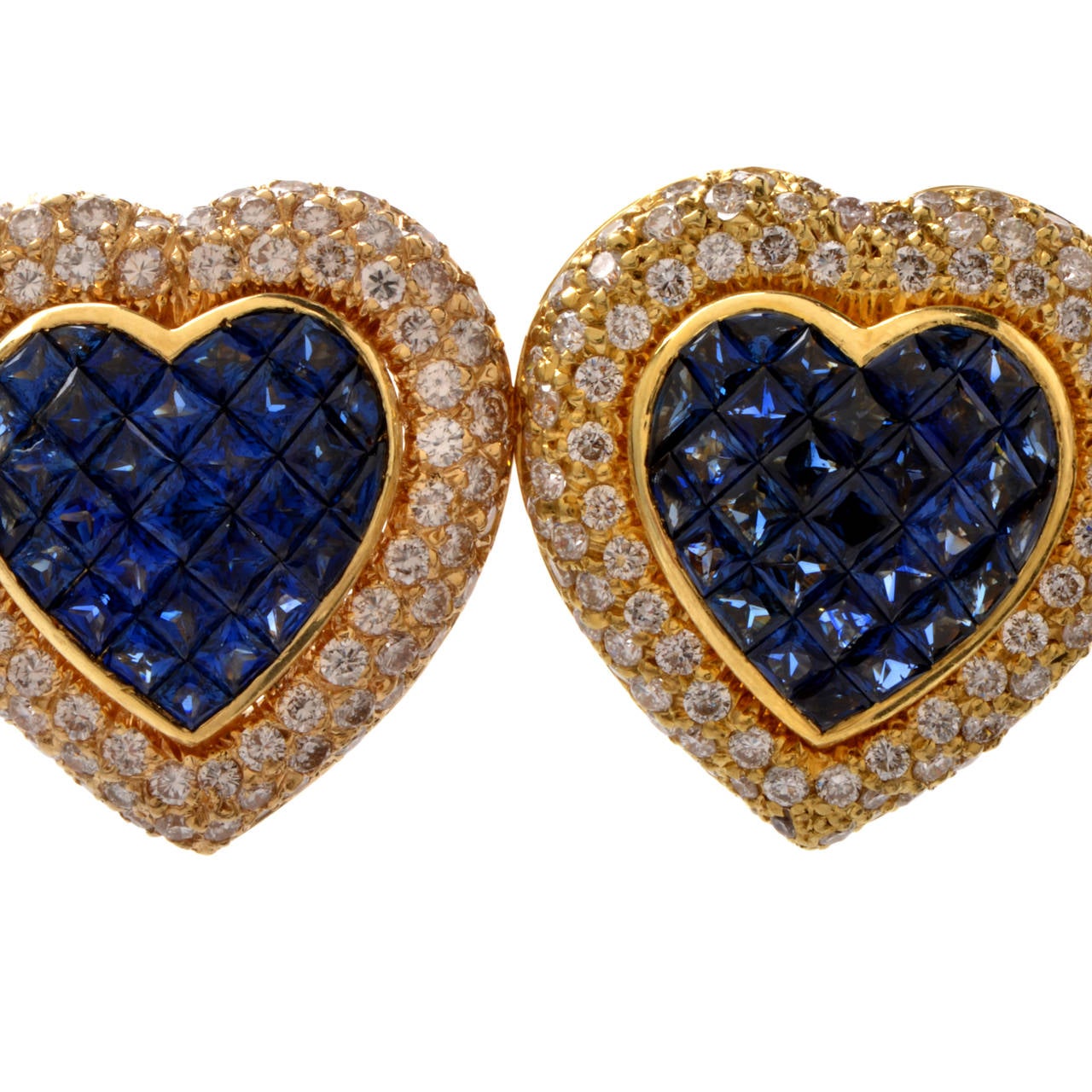 These estate heart earrings with sapphires and diamonds are crafted in and stamped with solid 18K yellow gold and weigh approx. 22.2 grams. Designed as a pair of color-contrasted heart-shaped profiles, these captivating earrings are adorned with 62