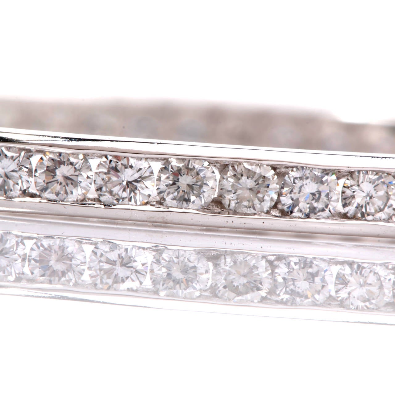 This stunning estate bangle bracelet is crafted in solid platinum. This bracelet is accented with some 67 genuine round brilliant cut diamonds approx 10.00cttw, G-H color, VS clarity, channel set. With an insert clasp, this bangle bracelet remains