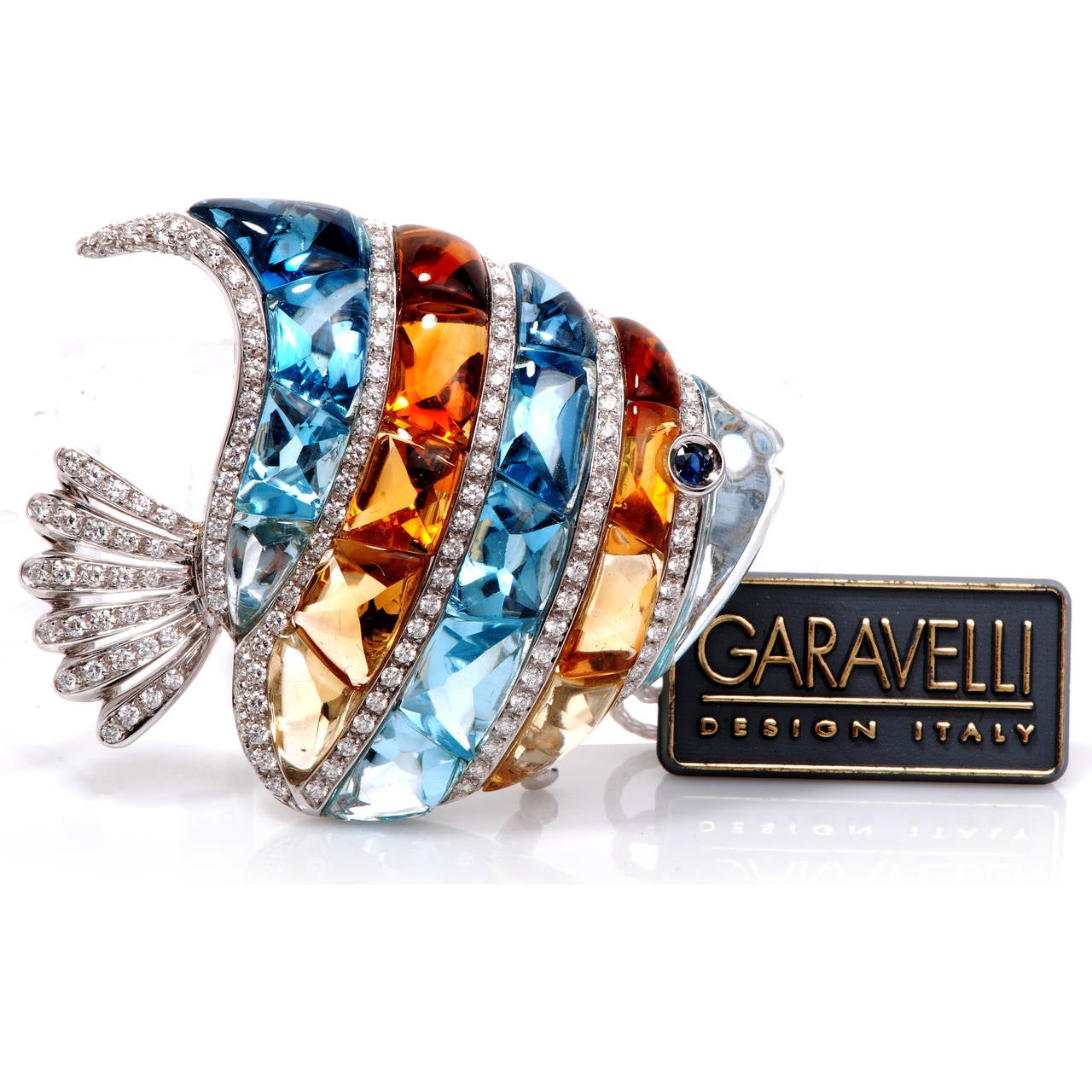 This adorable Garavelli Design Angel Fish pin is crafted beautifully in solid 18K white gold. This pin is accented with some 128 genuine pave set diamonds approx 3.00cttw, G color, VVS clarity, 10 calibrated cabochon genuine blue topaz and 9 genuine