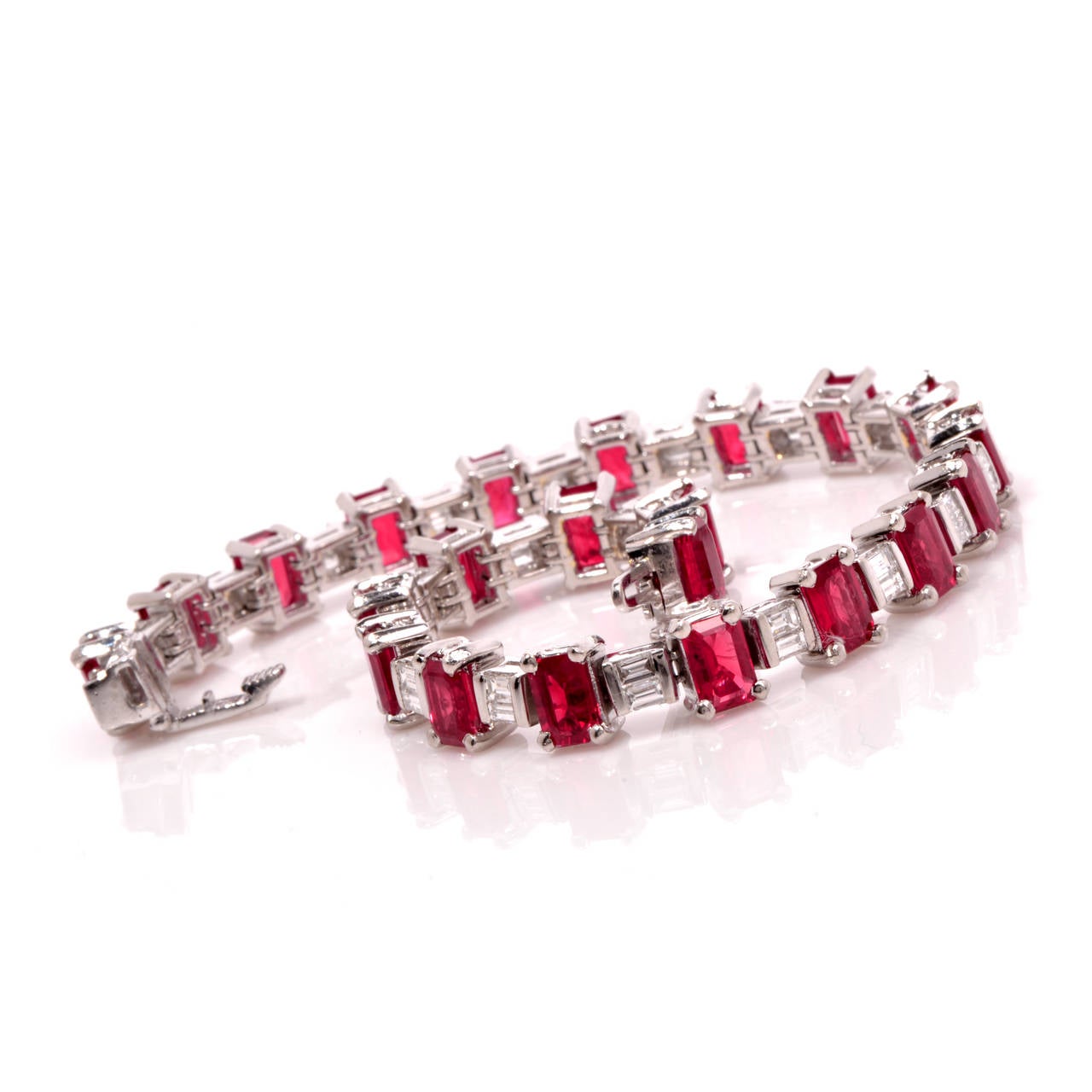 Add glamour with the perfect touch of color with this stunning line bracelet! Finely crafted in solid platinum, it is accented with a total of 22 genuine emerald cut  genuine Burma rubies approx. 17.60ct and 42 genuine baguette cut diamonds approx.