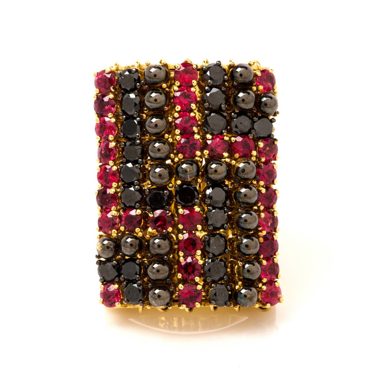 This majestic and very fashionable GARAVELLI ring is crafted in solid 18K yellow gold. This ring is centered with 21 genuine black diamonds approx 3.00cttw, some 28 genuine red sapphires approx 3.75cttw and some 21 genuine solid gold beads covered