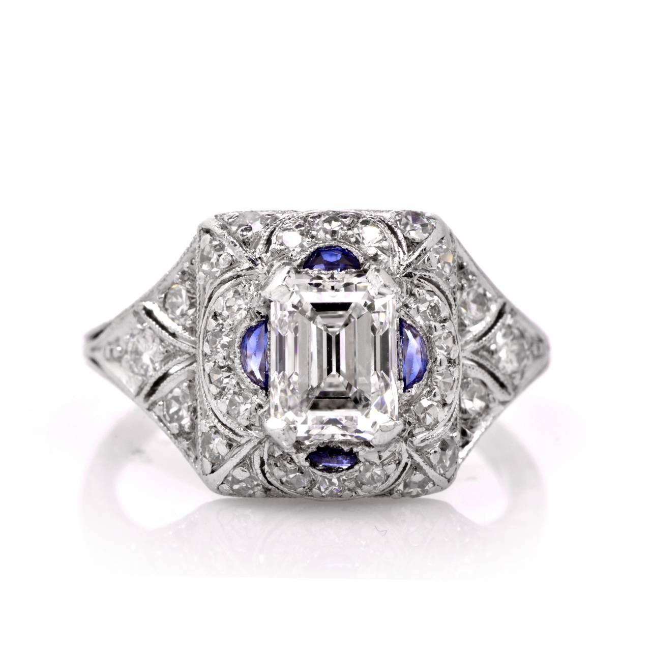 This engagement ring of timeless elegance and notable sparkle  is crafted in solid platinum, exposing a  genuine emerald cut diamond of approx. 0.95 ct, D-E color, VS clarity at the center. The eye-catching precious stone  is complemented by  4