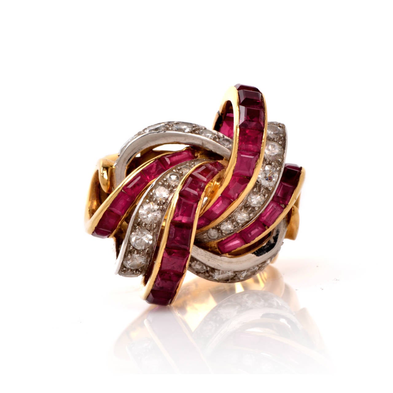 This authentic Retro cocktail French ring with diamonds and rubies is crafted in a combination of solid 18K yellow gold and solid platinum, weighing app.  18.2 grams and measuring app. 13mm high. Depicting the quintessential characteristics of the