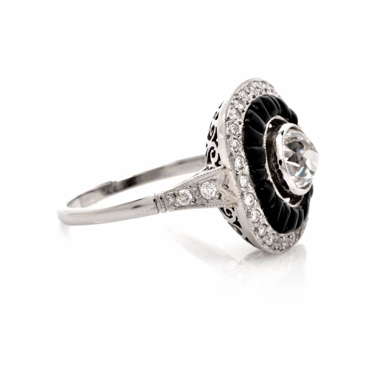 This antique Art Deco engagement ring with diamonds is crafted in solid platinum and weighs approx.  7.3 grams. Designed as a rounded quadrangular plaque, this quintessentially Art Deco engagement ring is centered with a significant 1.10 ct old