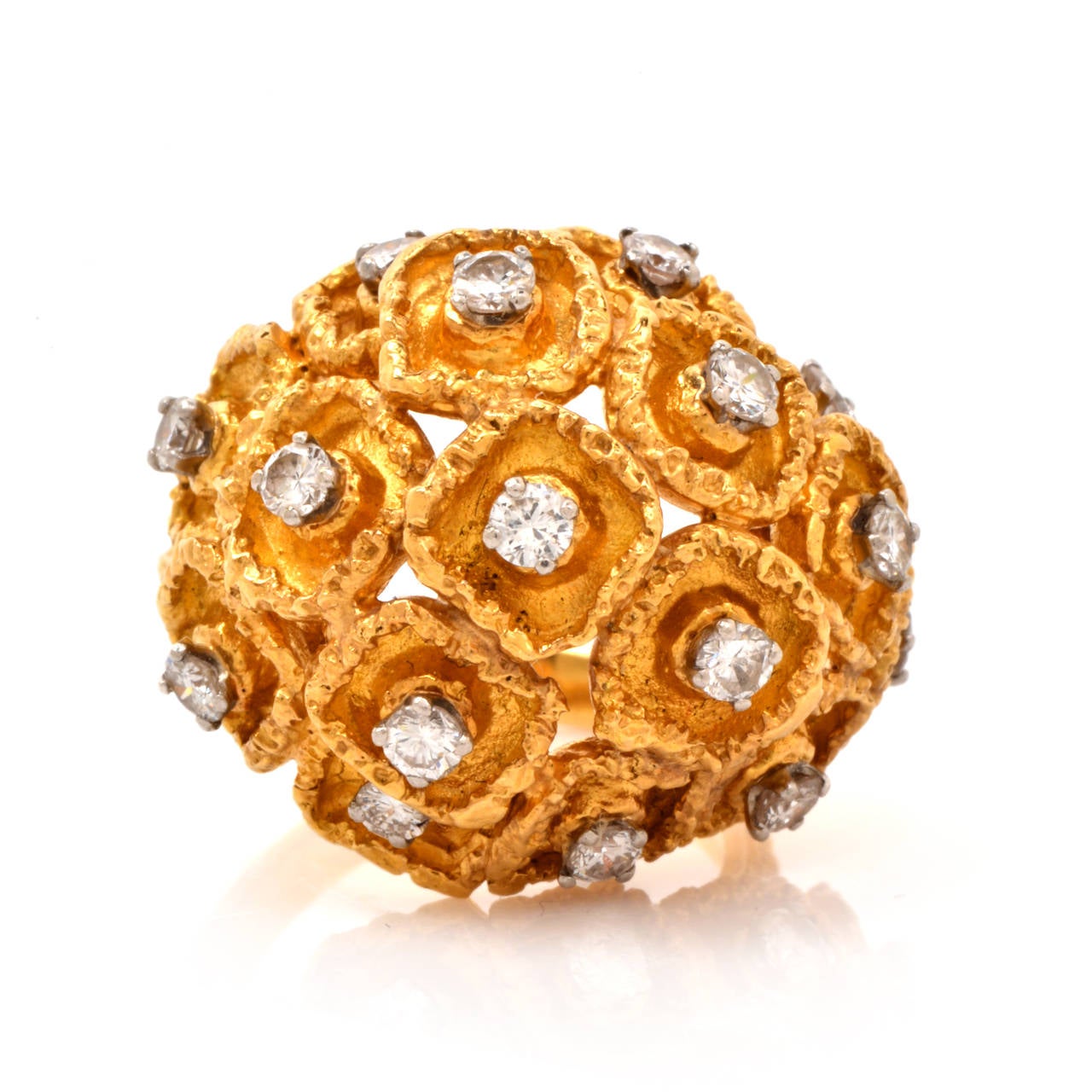 This cocktail ring of captivating design is crafted in solid 18K yellow gold weighing approximately 16.8 grams and measuring 18mm high. Designed as a diamond-adorned  dome plaque, comprising an assemblage of delicate floral profiles, this cocktail