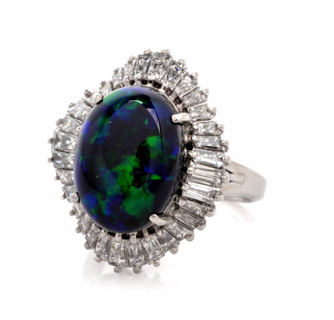 This captivating ballerina cocktail ring with a breathtaking black opal cabochon of rare color combination and baguette diamonds is crafted in solid platinum  and  weighs approximately 13.3 grams.  Incorporating an aesthetically enchanting ovular