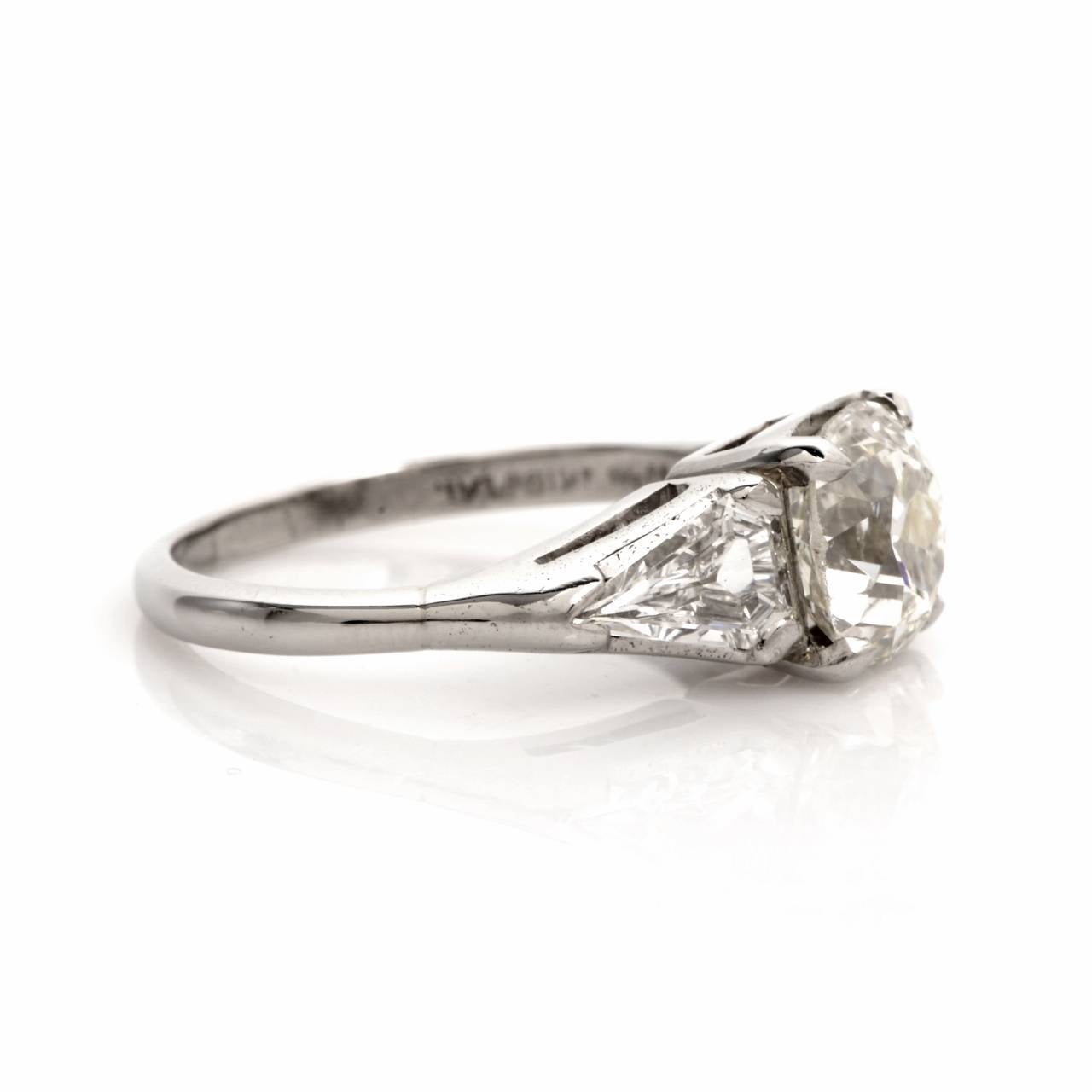 This alluring engagement ring is crafted in solid platinum, weighs approx. 4.8 grams and measures approx. 7.5 mm x 7 mm. Classically elegant  in design, this vintage engagement ring exposes a fiery old mine cut diamond weighing approx. 1.77 cts,