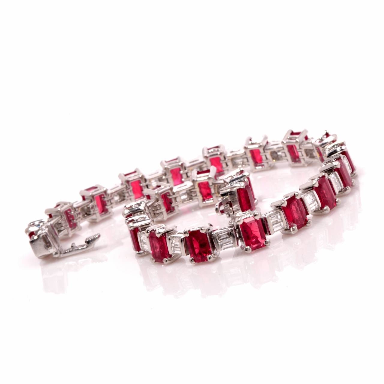Add glamor with the perfect touch of color with this stunning line bracelet! Finely crafted in solid platinum, it is accented with a total of 22 genuine emerald cut  genuine rubies approx. 17.60ct and 42 genuine baguette cut diamonds approx. 2.60ct,