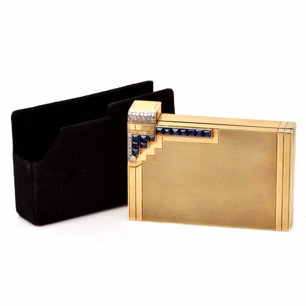 This 1930s authentic compact box with a lipstick holder, a powder compartment and a vanity mirror underneath the flap is crafted in solid 14K yellow gold, weighing 115.7 grams and measuring 2.8