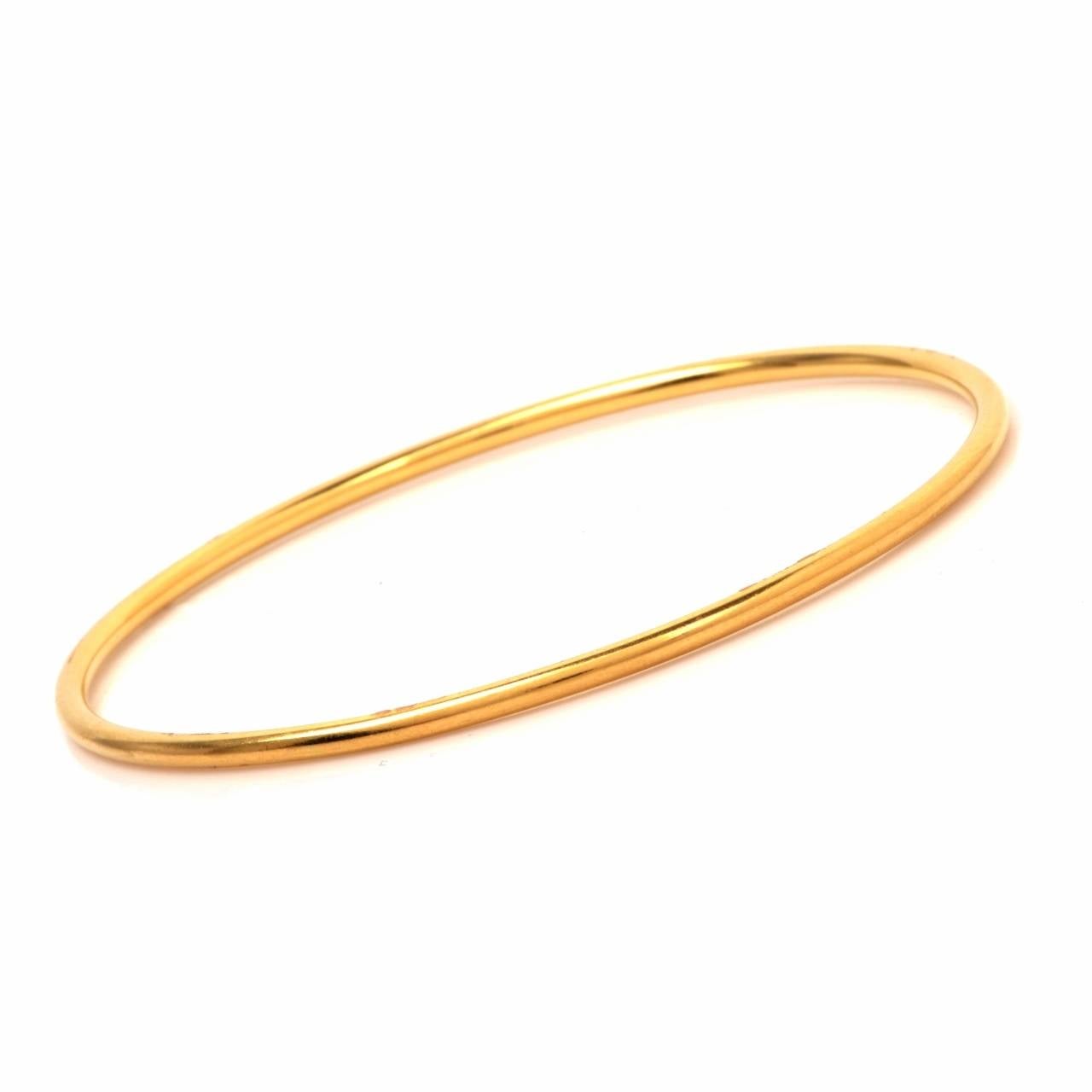 This stackable set of 12  bangle bracelets is handcrafted in solid 18K yellow gold, weighing approx. 172.9 grams. These bangle bracelets  measuring 2.6