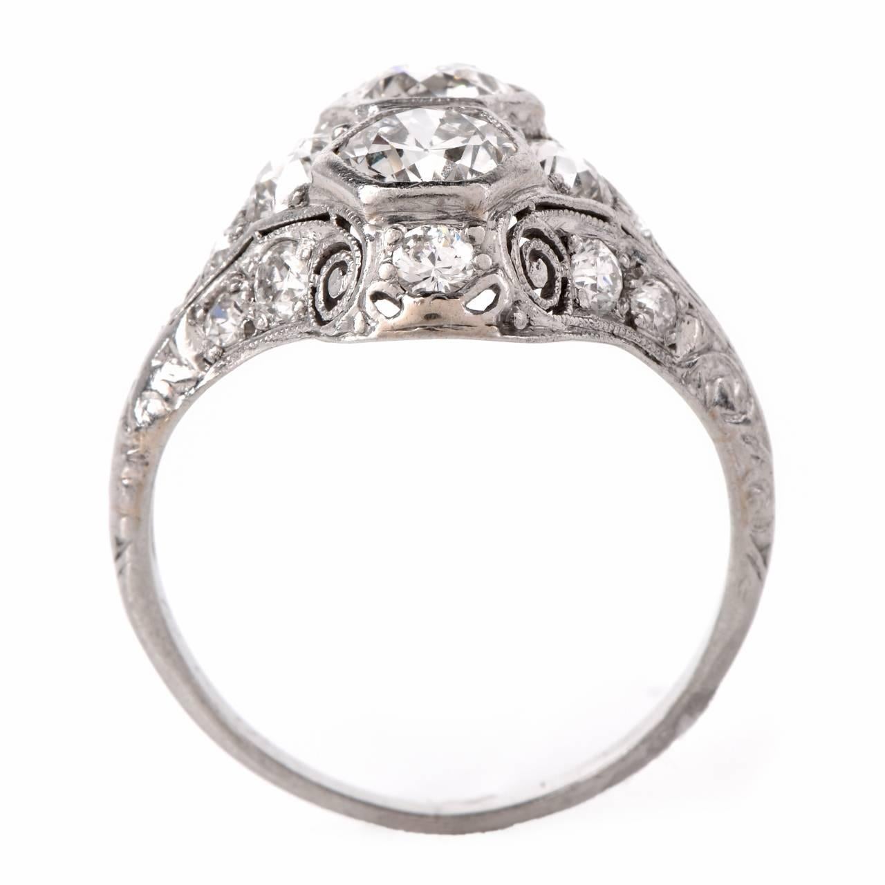 This antique Art Deco engagement ring with sparkling European-cut diamonds is crafted in solid platinum, weighing 3.5 grams and measuring 13mm wide. Incorporating a stylized hexagonal plaque, this alluringly feminine engagement ring is adorned with