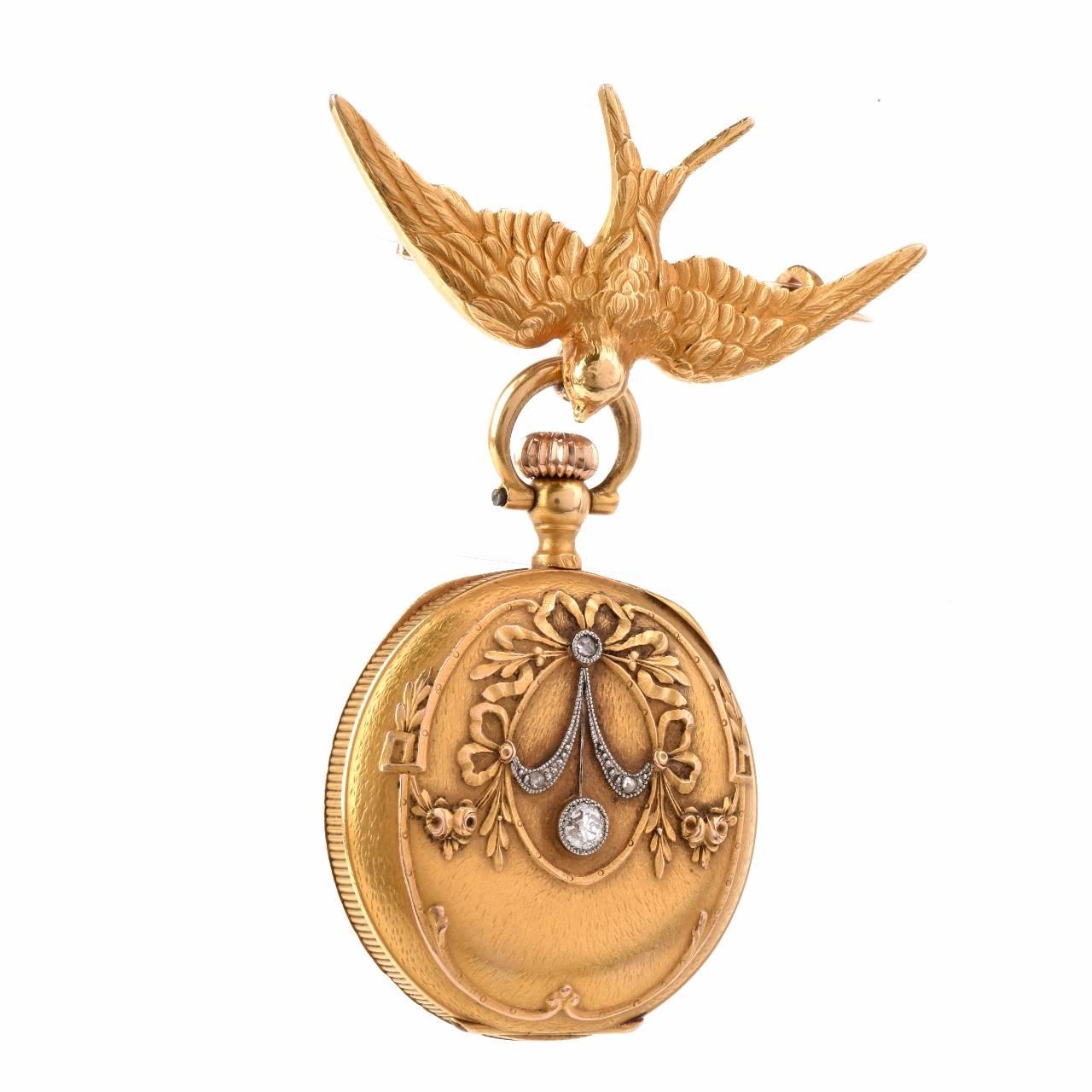 This antique Victorian (ca. 1895) ladies pocket watch and brooch, most probably of French provenance, is crafted in solid 18K yellow gold and weighs 29.7 grams. The highly ornate, open-face pocket watch measures 30 mm in diameter, featuring a white