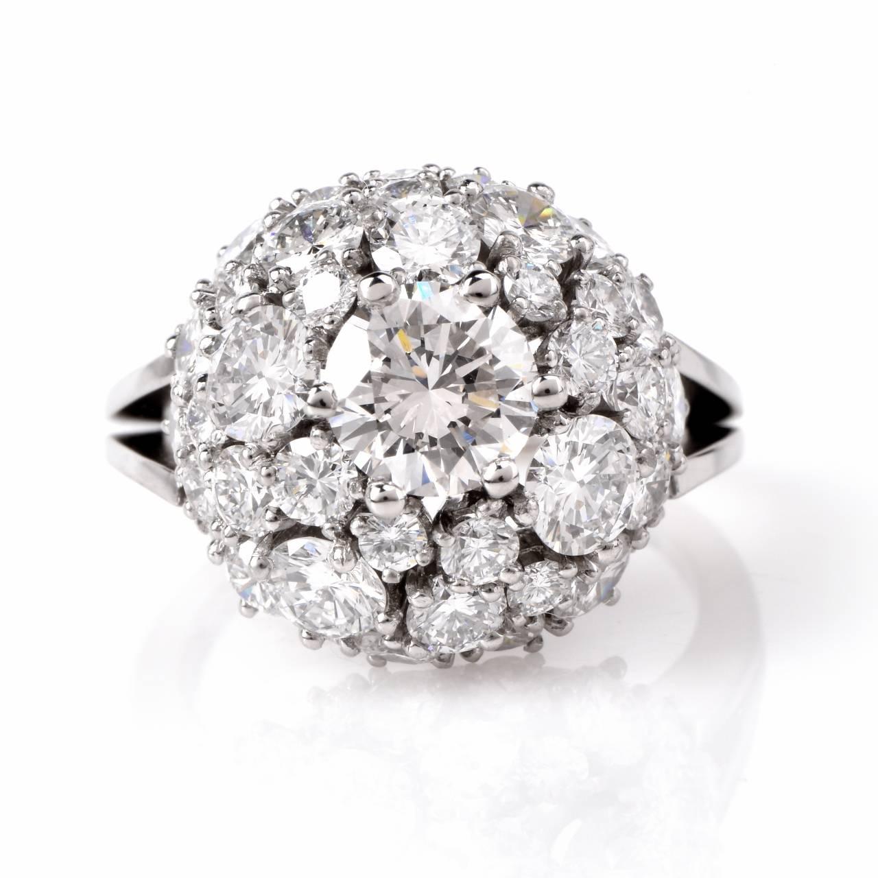 This stunning vintage cluster diamond engagement ring is crafted in solid 18K white gold. It is centered with 1 genuine round cut diamond approx 1.05cttw, H-I color, VS clarity, and surrounding the center stone are genuine round cut diamonds